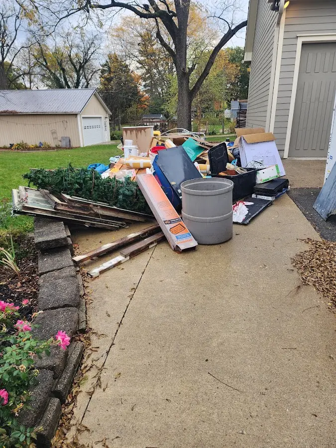 Dumpster being loaded with debris for Estate Cleanout Dumpster Rental in Ypsilanti